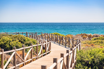 Cabopino beach, Marbella, Malaga. Wooden walkway to the beach.