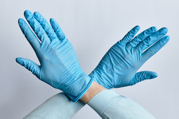 Abstract stop sign with hands in medical gloves.