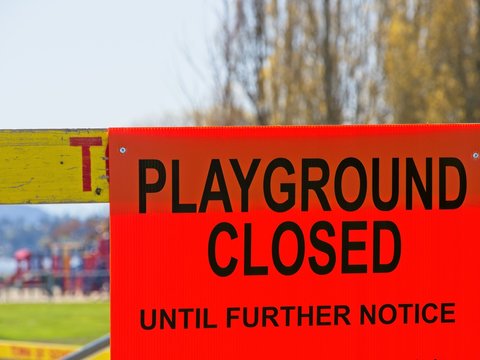 Playground closed due to coronavirus pandemic, red sign