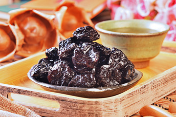 Dried black dates on black plate 