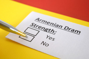 One person is answering question about strength of Armenian Dram.