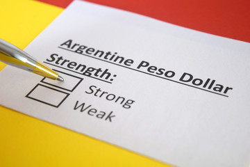 Fototapeta premium One person is answering question about strength of Argentine poso dollar.