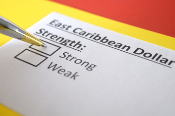 One person is answering question about strength of East caribbean dollar.