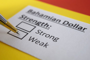 One person is answering question about strength of Bahamian dollar.