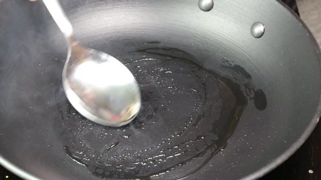 Cooking stuffed Paratha on a skillet with oil.