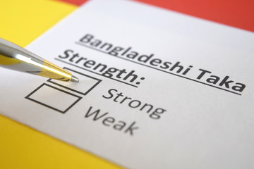 Obraz premium One person is answering question about strength of Bangladeshi Taka.