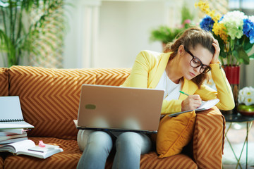 learner woman in modern living room in sunny day study online