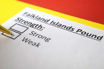 Fototapeta premium One person is answering question about strength of Falkland Islands Pound.