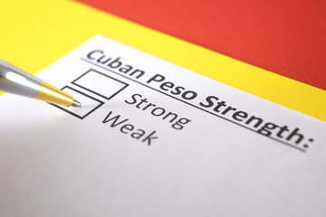 Fototapeta premium One person is answering question about strength of Cuban Peso.