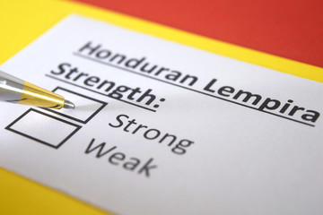 Obraz premium One person is answering question about strength of Honduran Lempira currency.