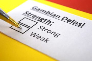 Obraz premium One person is answering question about strength of Gambian Dalasi.