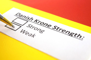 Obraz premium One person is answering question about strength of Danish Krone.