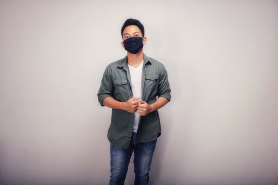 Vintage version of An Asian short hair man wears black mask.