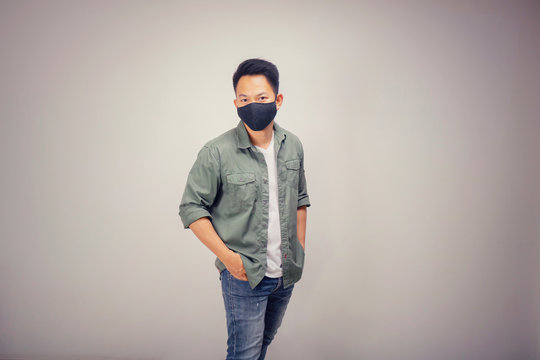 Vintage version of An Asian short hair man wears black mask.