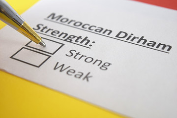 Obraz premium One person is answering question about strength of Moroccan Dirham.