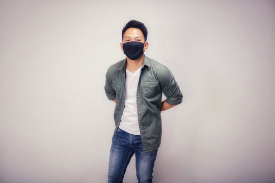 Vintage version of An Asian short hair man wears black mask.
