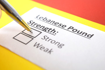 One person is answering question about strength of Lebanese Pound.