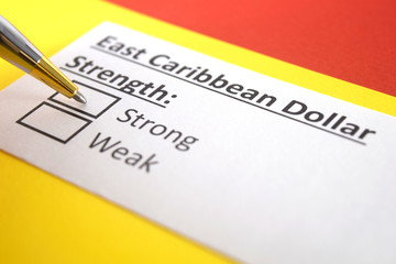 Obraz premium One person is answering question about strength of East Caribbean Dollar.