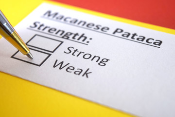 Obraz premium One person is answering question about strength of Macanese Pataca.