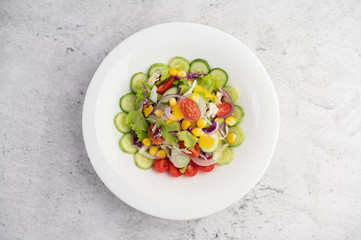 Fototapeta na wymiar Vegetable salad with boiled eggs in a white dish.