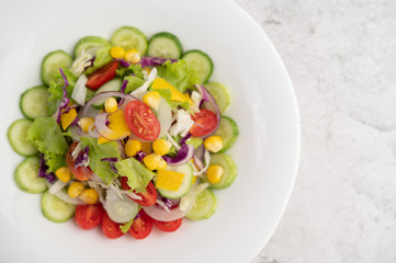 Vegetable salad with boiled eggs in a white dish.