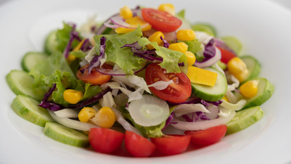 Vegetable salad with boiled eggs in a white dish.
