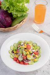 Vegetable salad with boiled eggs in a white dish.