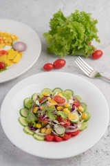 Vegetable salad with boiled eggs in a white dish.