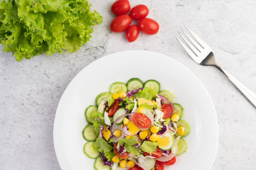 Vegetable salad with boiled eggs in a white dish.