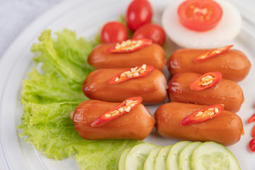 Sausage placed on a white plate.