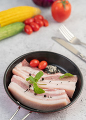Pork belly in a pan with pepper seeds Tomatoes and spices