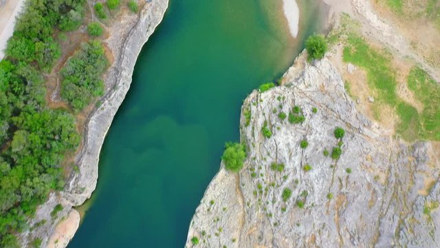 Low altitude aerial of Pont du Gard is an ancient Roman aqueduct that crosses the Gardon River near the town of Vers-Pont-du-Gard in southern France and popular tourist destination 4k