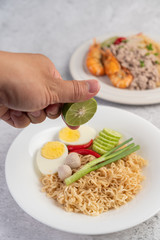 Mama with boiled eggs in a white dish.