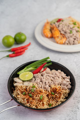 Mama with minced pork in a frying pan.