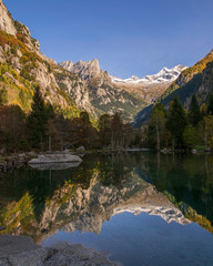 Majestic glaciers are reflected in the waters of an alpine lake. Valtellina 