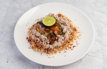 Mama noodle overlaid with minced pork, canned fish and lemon.