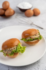 Tuna salad wrapped with bread and lettuce.