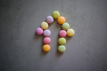 arrow of colorful candies on a gray table