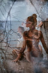 beautiful young woman covered with fabric and blindfolded. double exposure concept
