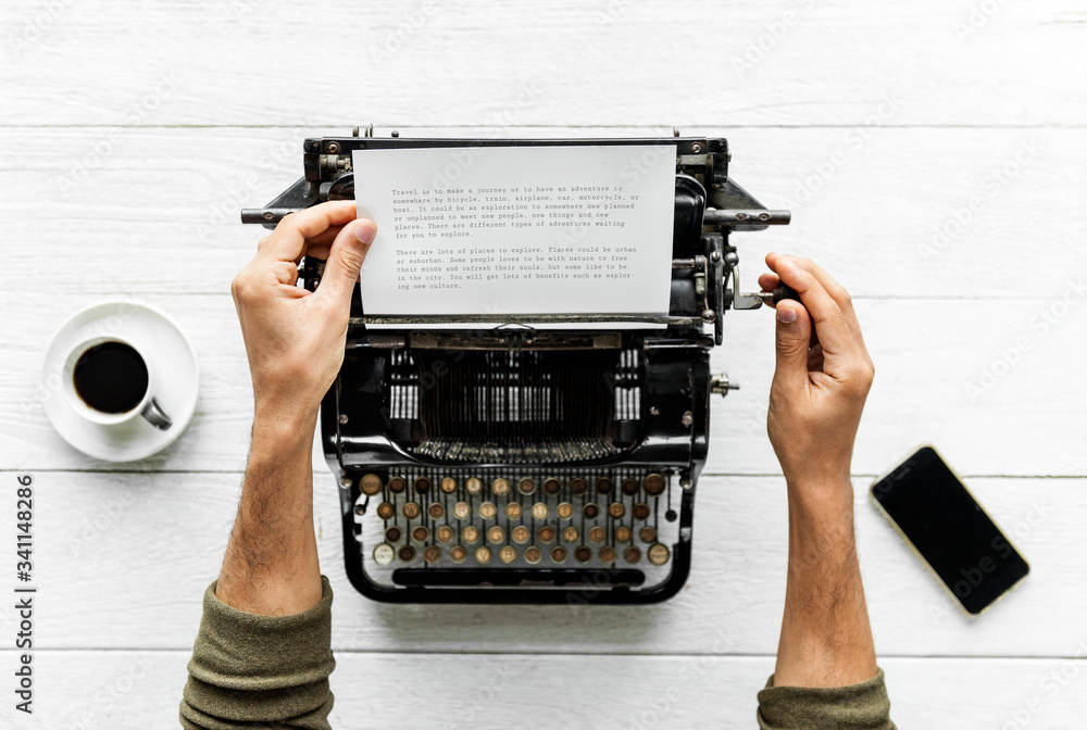 Poster aerial view of a man typing on a retro typewriter