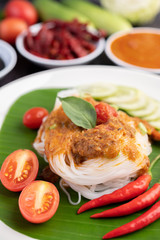 Rice noodle noodles topped with coconut milk.