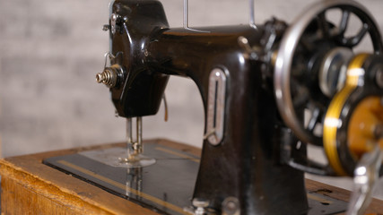 Close up of old manual sewing machine on table.