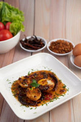 Boiled eggs stir-fried with tamarind sauce.