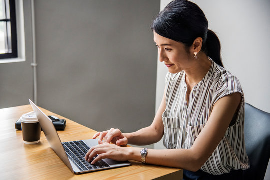 Japanese Woman Working On A Laptop