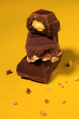 Brown chocolate filled with yellow cream and nuts