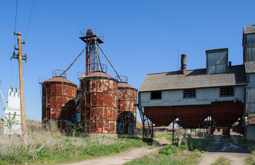 old metal silos for grain, a wooden fence with barbed wire © kurtov