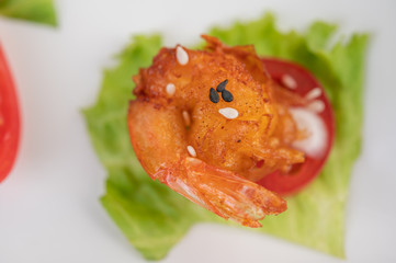 Shrimp deep-fried batter arranged beautifully in a white dish.