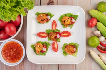 Shrimp deep-fried batter arranged beautifully in a white dish.