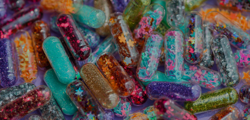 Closeup of glittery shimmery shiny pills capsule background