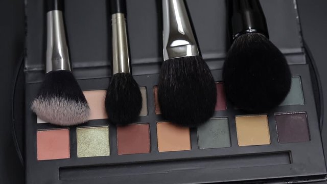 The palette of shadows rotates. Palette of eyeshadows close-up.